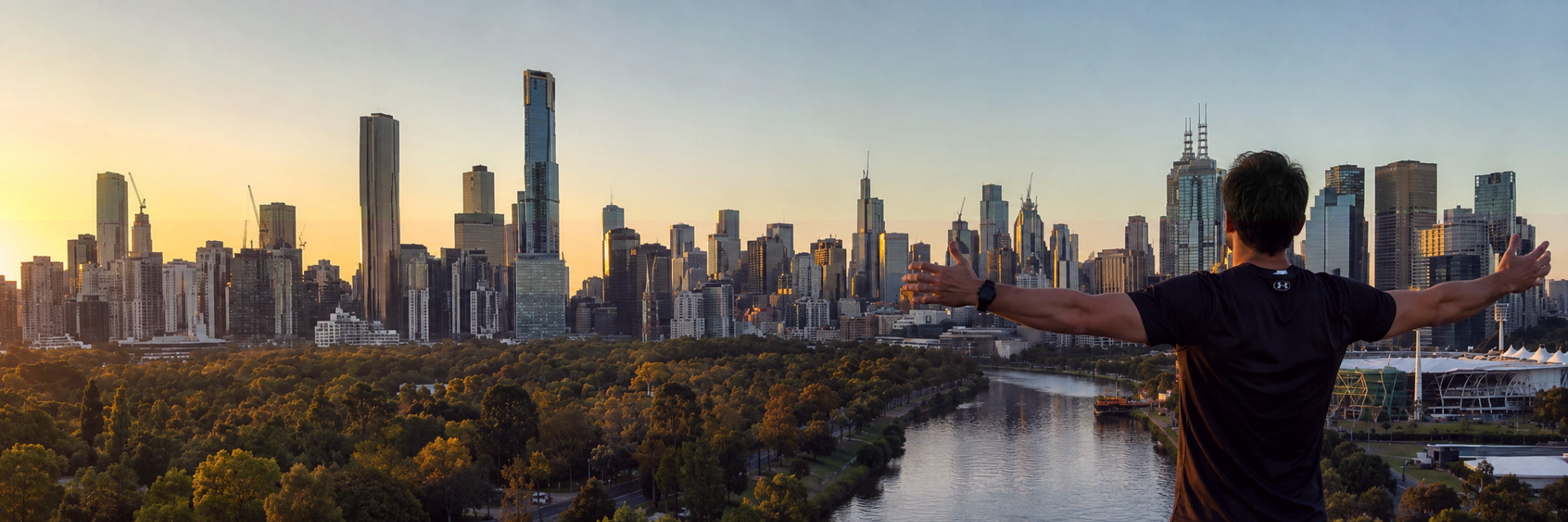Person overlooking the Melbourne skyline at sunset